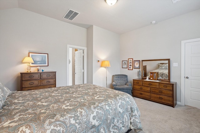 bedroom with lofted ceiling and light carpet