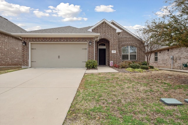 view of front of house featuring a garage, driveway, brick siding, and a shingled roof