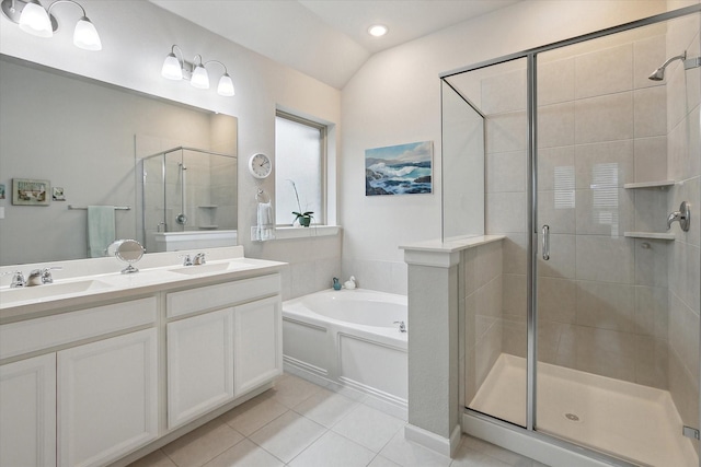 full bath featuring a stall shower, a garden tub, a sink, and tile patterned floors