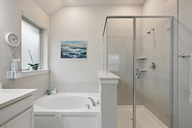 bathroom with vaulted ceiling, a stall shower, vanity, and a bath