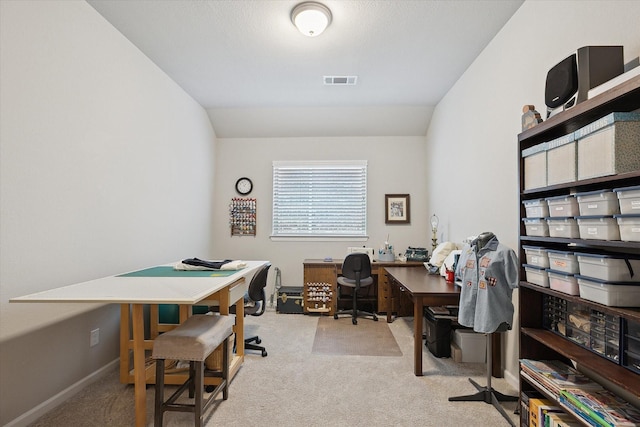 office space featuring baseboards, visible vents, vaulted ceiling, and carpet flooring