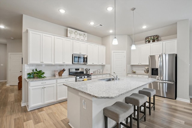 kitchen featuring white cabinetry, sink, and appliances with stainless steel finishes