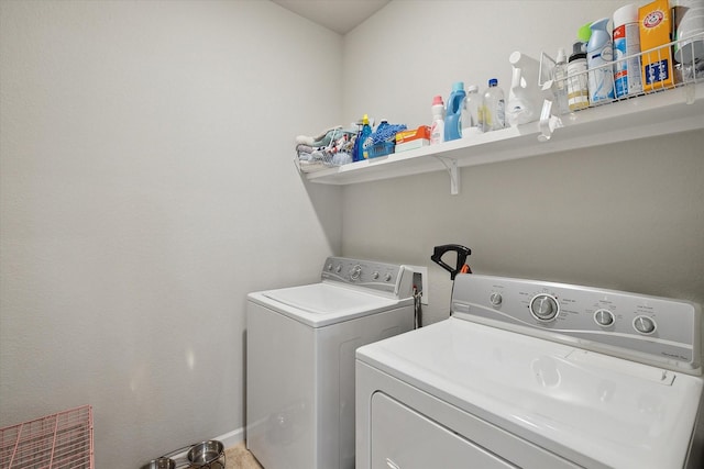 clothes washing area with laundry area, visible vents, washer and clothes dryer, and baseboards