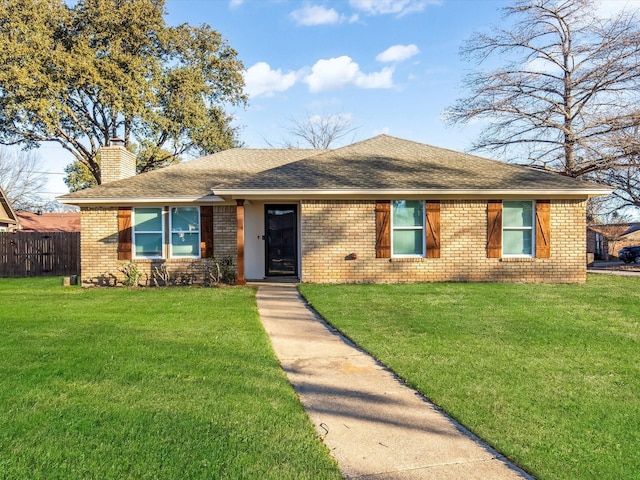 ranch-style house with brick siding, a chimney, and a front lawn