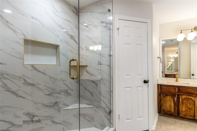 bathroom with vanity and a marble finish shower