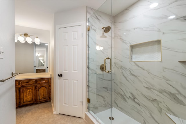 full bath featuring a marble finish shower and vanity