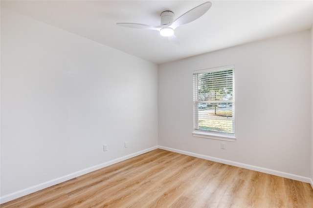 unfurnished room with ceiling fan, light wood-style flooring, and baseboards