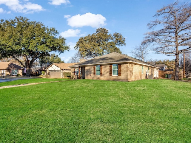 single story home with a front yard, a chimney, and brick siding