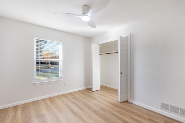 unfurnished bedroom featuring light wood-style floors, a closet, visible vents, and baseboards