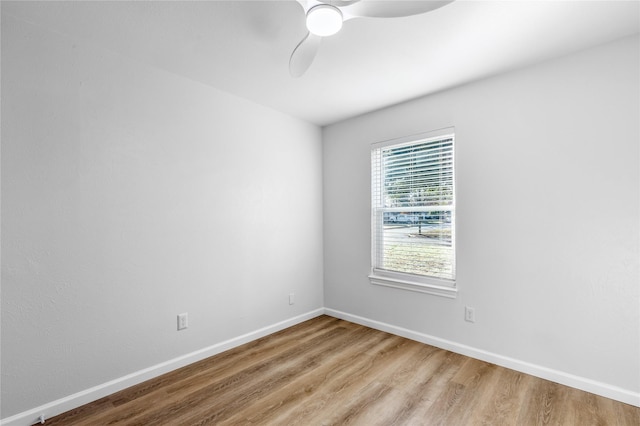 empty room featuring ceiling fan, wood finished floors, and baseboards