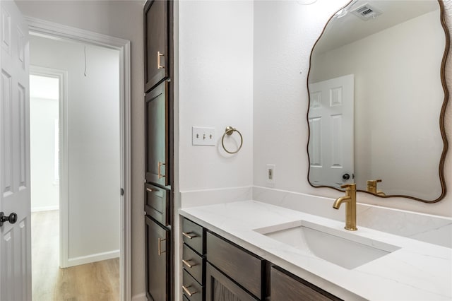 bathroom with visible vents, wood finished floors, and vanity