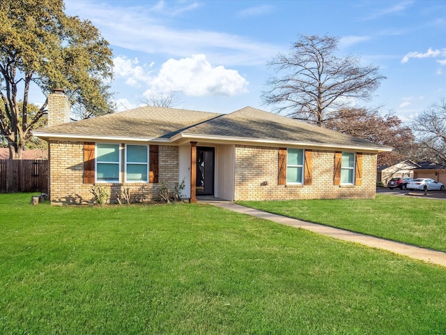 ranch-style home featuring brick siding, a chimney, fence, and a front yard