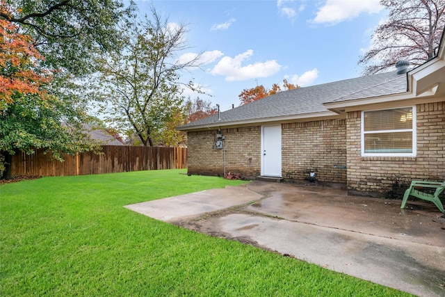 view of yard with fence and a patio