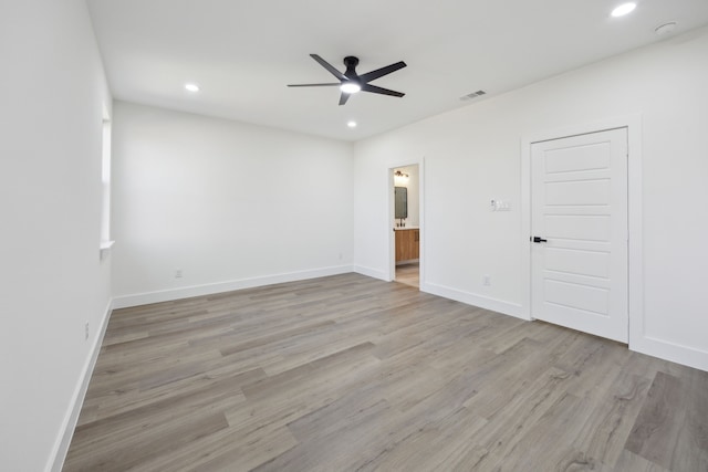 unfurnished room with ceiling fan and light wood-type flooring