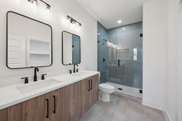 bathroom with tile patterned flooring, vanity, an enclosed shower, and toilet