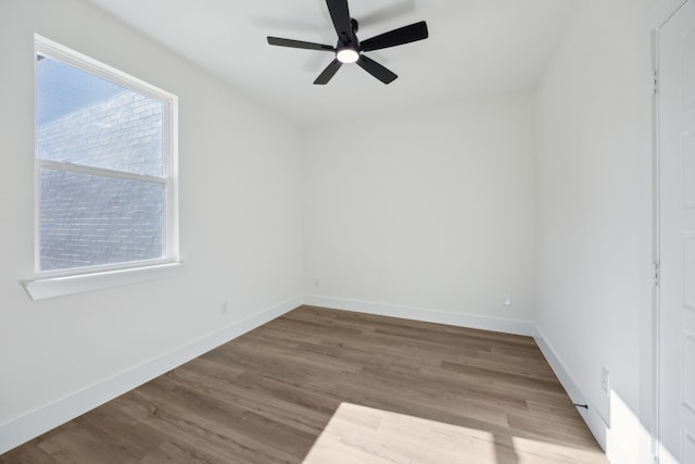 spare room with ceiling fan and hardwood / wood-style floors