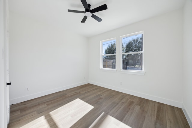 spare room with hardwood / wood-style floors and ceiling fan