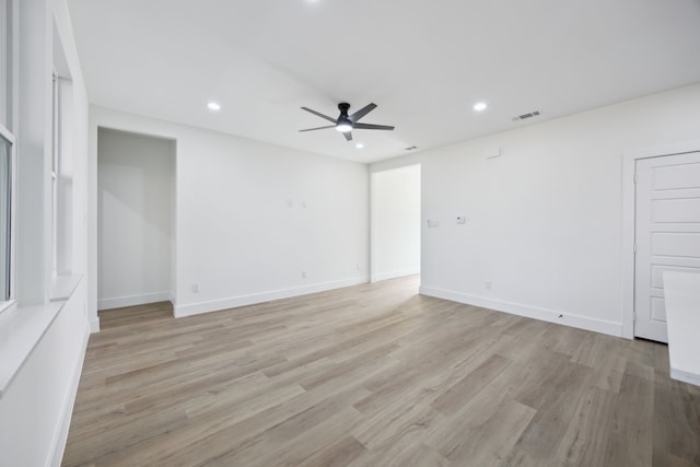 unfurnished room with ceiling fan and light wood-type flooring