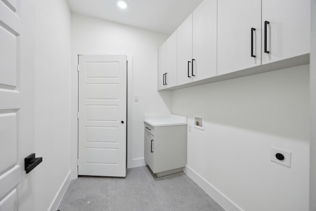 laundry room featuring cabinets, light tile patterned floors, hookup for a washing machine, and electric dryer hookup