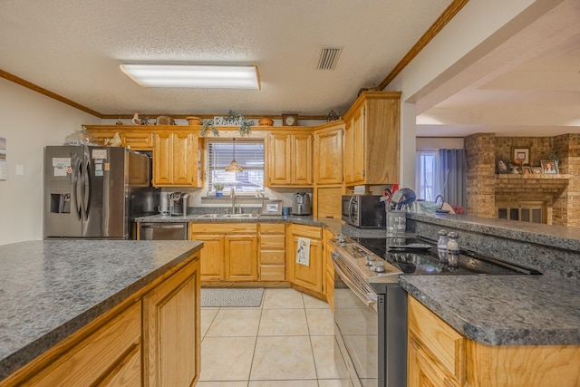 kitchen with light tile patterned flooring, sink, stainless steel appliances, crown molding, and a textured ceiling