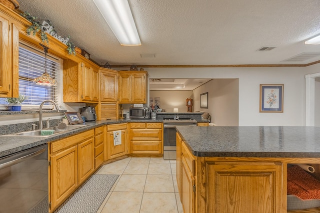 kitchen with stainless steel appliances, sink, light tile patterned floors, and a textured ceiling