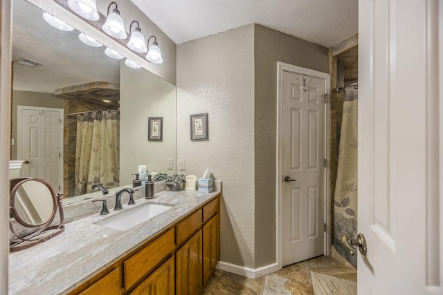 bathroom with walk in shower and vanity