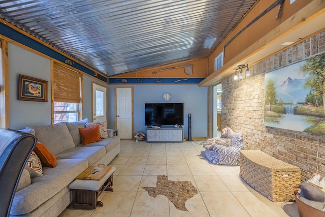 living room with lofted ceiling, brick wall, and light tile patterned floors