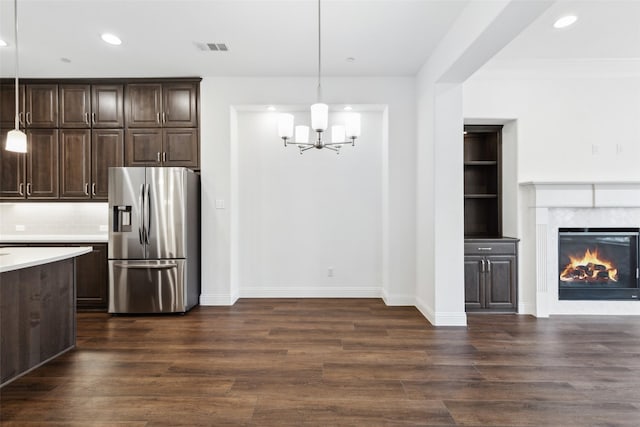 kitchen featuring hanging light fixtures, dark brown cabinets, dark hardwood / wood-style floors, and stainless steel fridge with ice dispenser