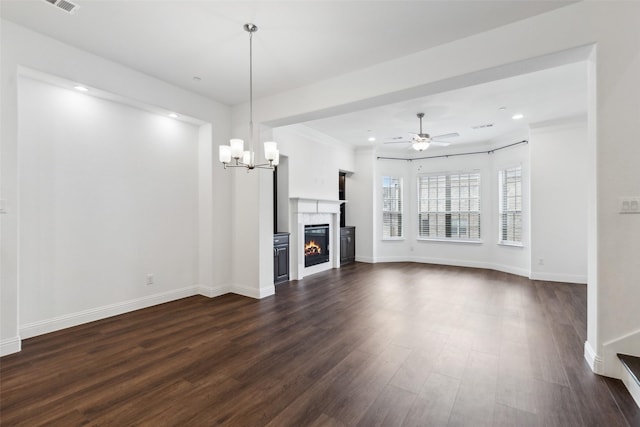 unfurnished living room featuring dark hardwood / wood-style flooring and ceiling fan with notable chandelier