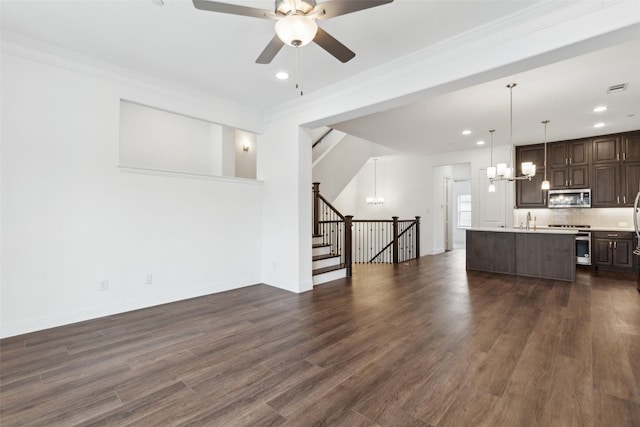 unfurnished living room with crown molding, sink, dark hardwood / wood-style floors, and ceiling fan with notable chandelier