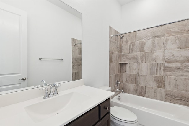 full bathroom with tiled shower / bath, vanity, and toilet