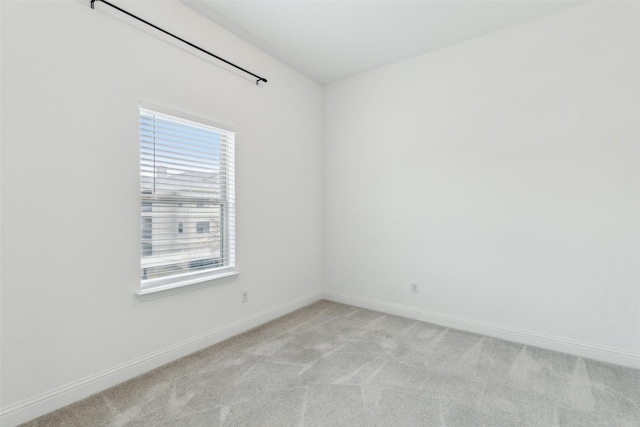 spare room featuring light colored carpet