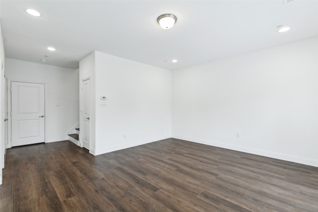 empty room with dark hardwood / wood-style floors