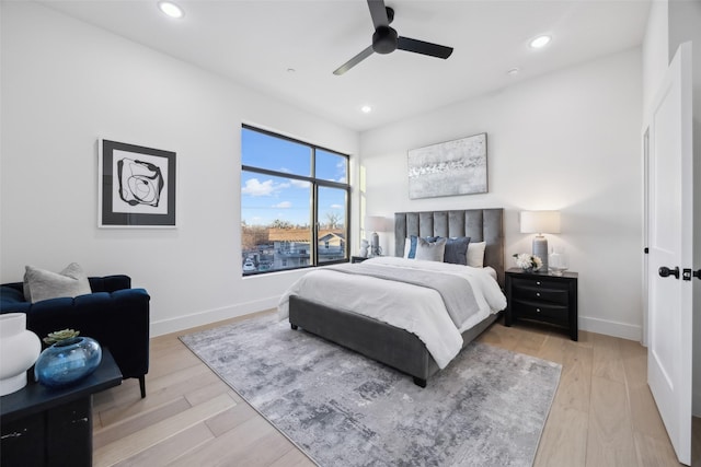 bedroom with ceiling fan and light hardwood / wood-style floors