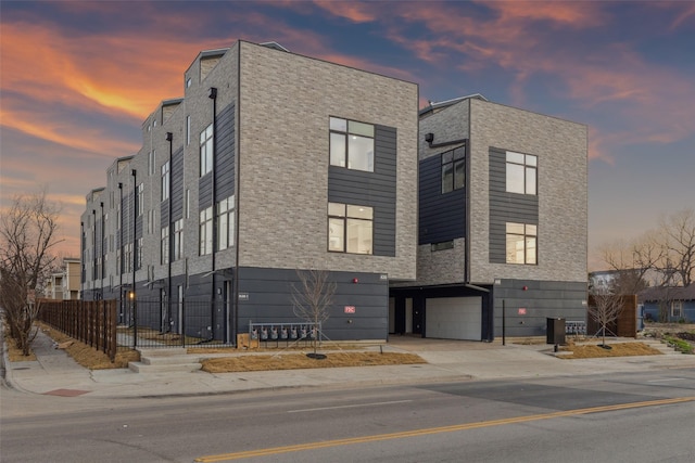 outdoor building at dusk featuring a garage