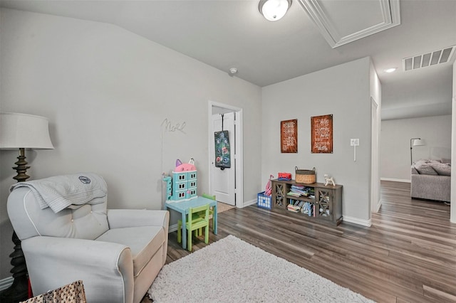 sitting room featuring hardwood / wood-style flooring and lofted ceiling