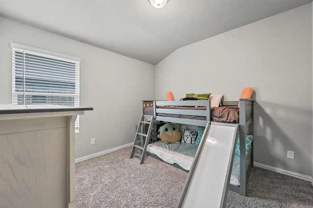 bedroom with vaulted ceiling and carpet flooring