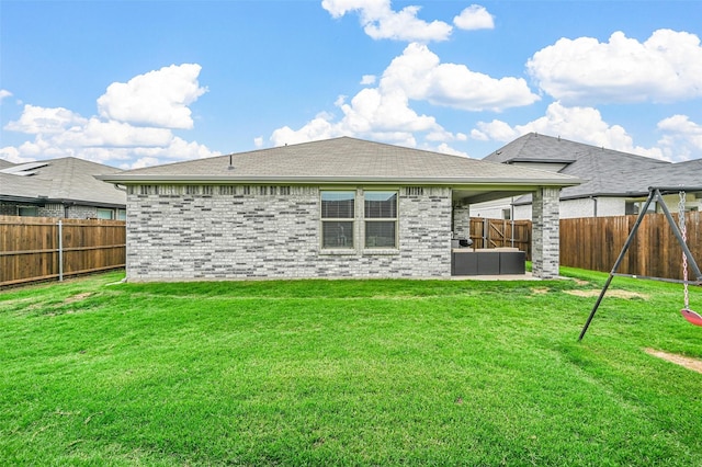 back of house with an outdoor living space and a lawn