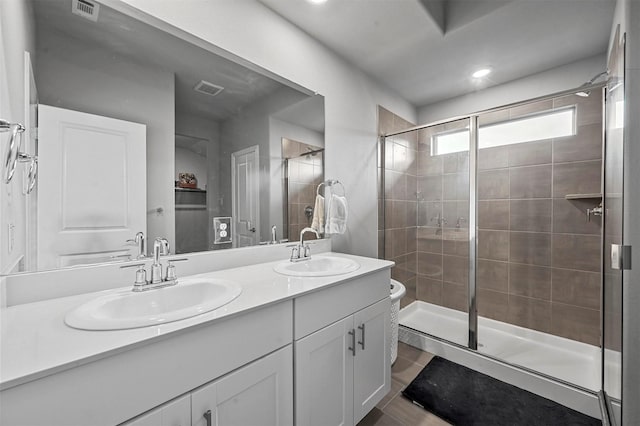 bathroom featuring vanity, tile patterned flooring, and walk in shower