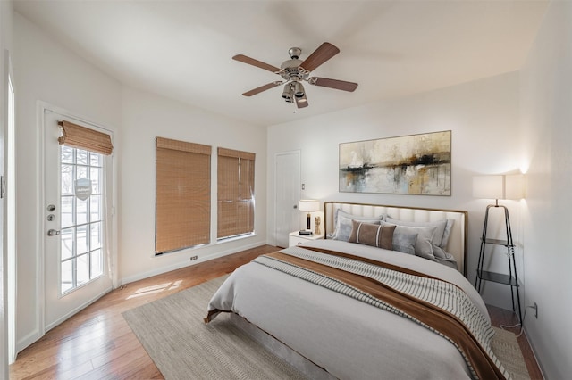 bedroom with ceiling fan, access to exterior, and light hardwood / wood-style floors