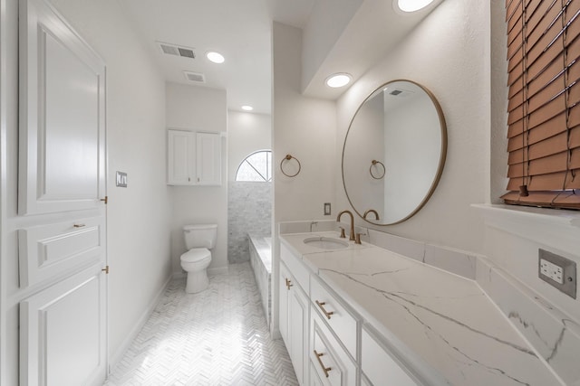 bathroom featuring vanity, toilet, and tile patterned flooring