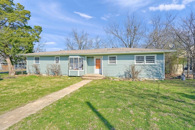 single story home featuring a front lawn