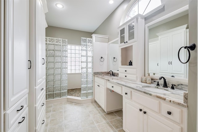 bathroom featuring vanity, tile patterned flooring, and a shower