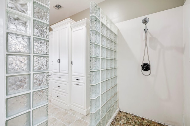 bathroom with tile patterned flooring and a shower