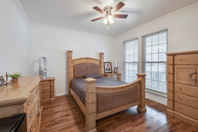 bedroom featuring dark wood-type flooring, ceiling fan, and ornamental molding