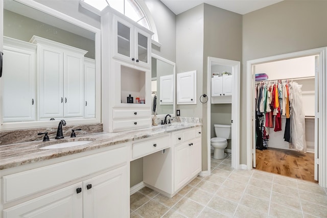 bathroom featuring tile patterned flooring, vanity, and toilet