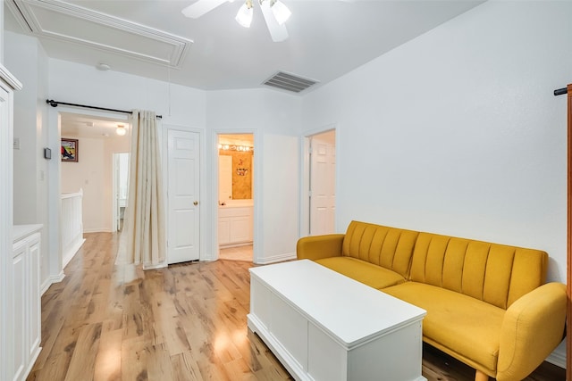 living room featuring ceiling fan and light wood-type flooring