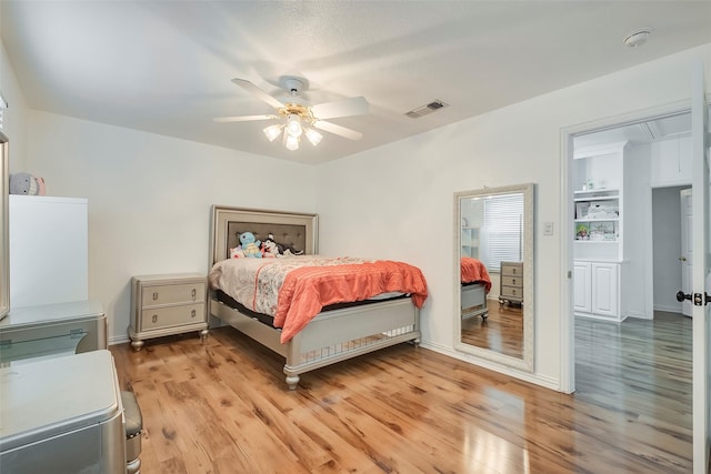 bedroom with ceiling fan and light wood-type flooring