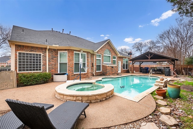 view of swimming pool with a gazebo, a patio area, and an in ground hot tub