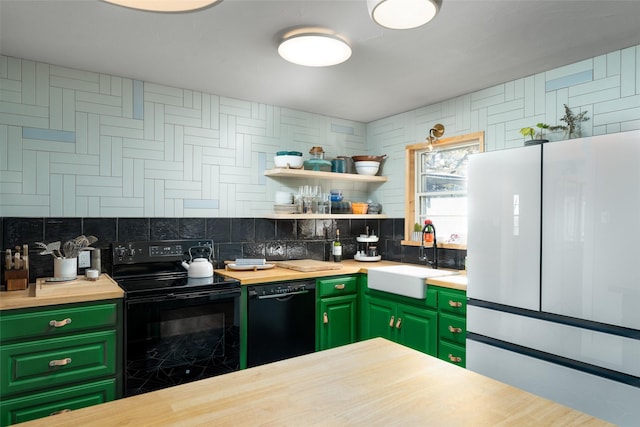 kitchen with butcher block counters, sink, black appliances, and green cabinets